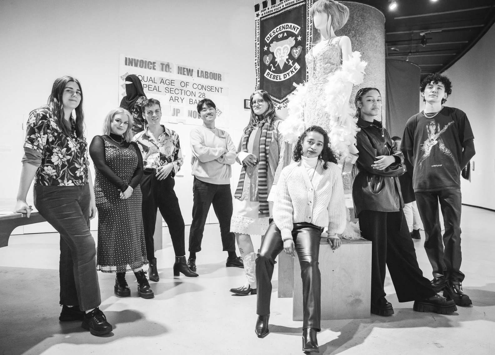 group photo of the Barbican Young Archivists, eight people standing in a gallery space